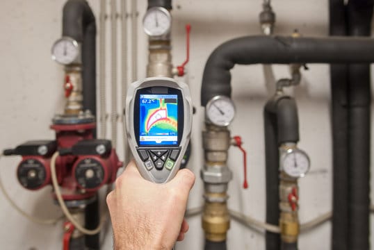 Plumber using a thermal imaging camera to inspect pipes in Louisville