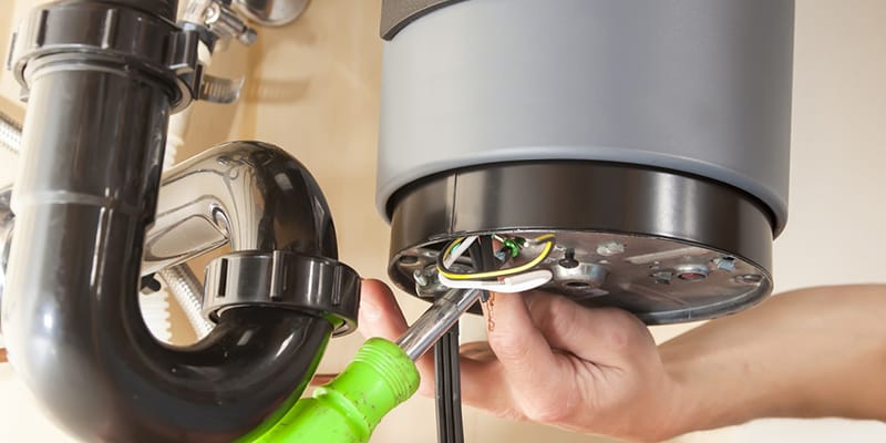 Technician repairing the heating element of a water heater in Louisville