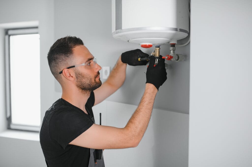 Technician performing water heater maintenance in Louisville